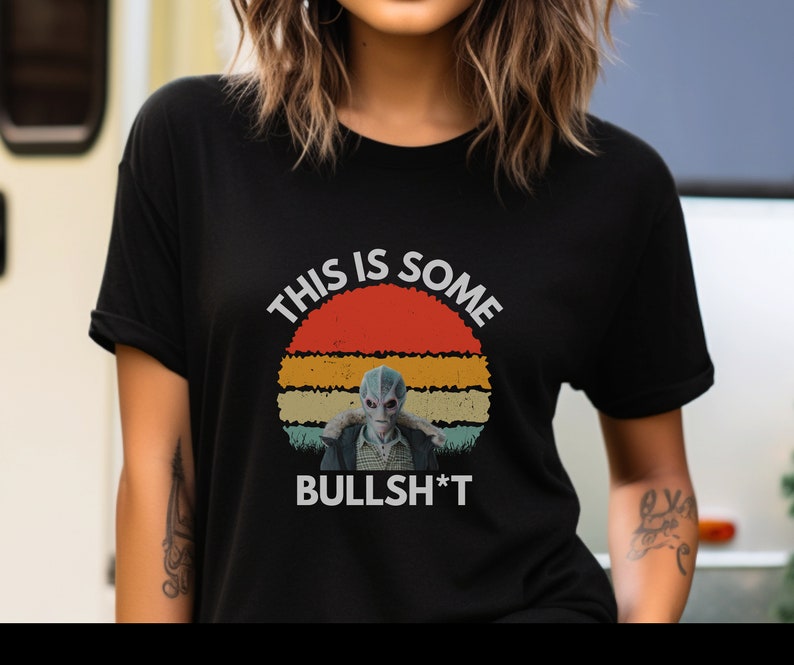 May include: Black t-shirt with a vintage-style graphic of a blue alien with the text "This is some Bullsh*t".
