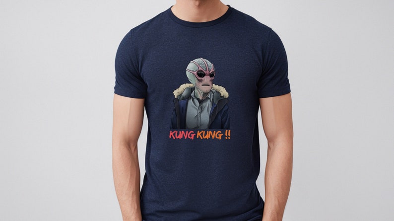 May include: A navy blue t-shirt with a graphic of a grey alien wearing a brown jacket and the text "KUNG KUNG!!" in red.