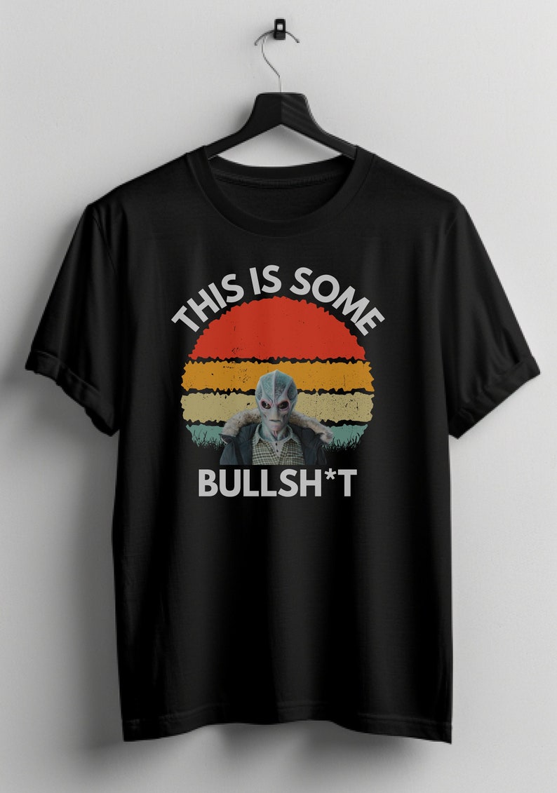 May include: Black t-shirt with a retro sunset graphic and an alien figure. The text "This is some BULLSH*T" is printed on the shirt.