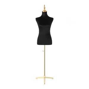 May include: A black velvet mannequin torso on a gold metal stand with a tripod base.