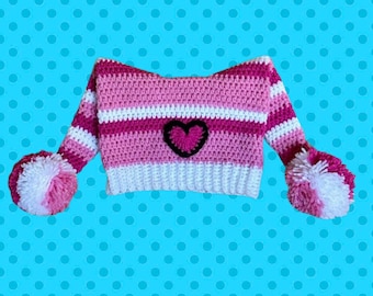 May include: Pink and white striped crocheted hat with a pink heart on the front and white pom-poms on the ends.