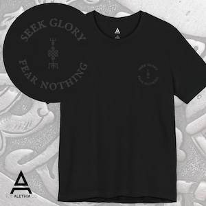 May include: Black crew neck t-shirt with the text "SEEK GLORY FEAR NOTHING" in a circular design. The shirt also features a small logo on the upper chest. The brand logo is at the bottom of the image.