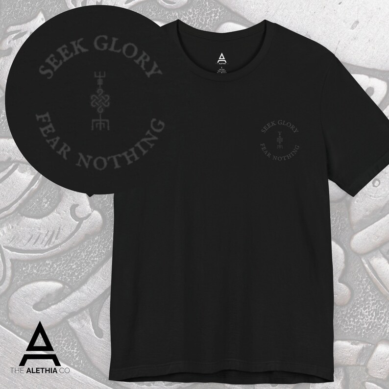 May include: Black crew neck t-shirt with the text "SEEK GLORY FEAR NOTHING" in a circular design. The shirt also features a small logo on the upper chest. The brand logo is at the bottom of the image.