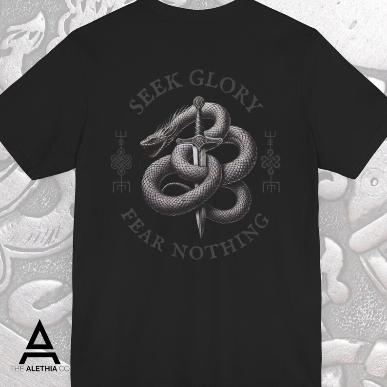 May include: Black t-shirt featuring a detailed graphic of a serpent coiled around a sword. The text "SEEK GLORY FEAR NOTHING" is arched above and below the image. The Alethia Co. logo is at the bottom.