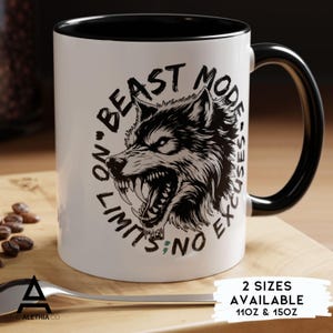 May include: White ceramic mug with a black interior and handle. The mug features a detailed black and white illustration of a snarling wolf with the text "BEAST MODE, NO EXCUSES, NO LIMITS".