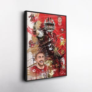 May include: Framed artwork depicting a football player in a red and gold uniform. The artwork has a red and gold colour scheme with a splatter paint effect. Additional illustrations of players are included.