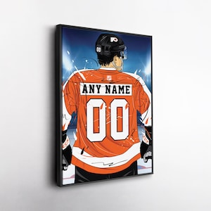 May include: Framed artwork of a hockey player in an orange jersey with the text "ANY NAME" and the number "00". The player is viewed from the back, wearing a black helmet and gloves. The background shows a hockey rink with bright lights.