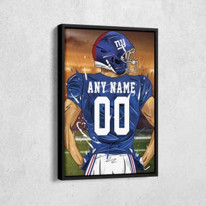 May include: Framed artwork of a football player in a blue uniform with the text "ANY NAME" and the number "00". The player is wearing a blue helmet with "ny" on it. The background is a blurred stadium scene.