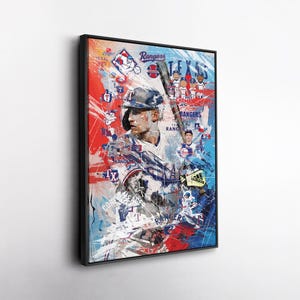 May include: A framed art print featuring a baseball player in a Texas Rangers uniform. The artwork uses a mix of red, white, and blue colors with the words "Texas Rangers" and "Champions" visible. The player is holding a baseball bat.