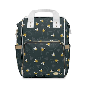 May include: A dark green backpack with a white trim and a pattern of yellow fireflies. The backpack has a top handle and adjustable straps.