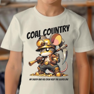 May include: A white t-shirt with a cartoon image of a mouse wearing a miner's helmet and holding a pickaxe. The text "COAL COUNTRY" is above the image and "MY DADDY AND HIS CREW KEEP THE LIGHTS ON!" is below the image.