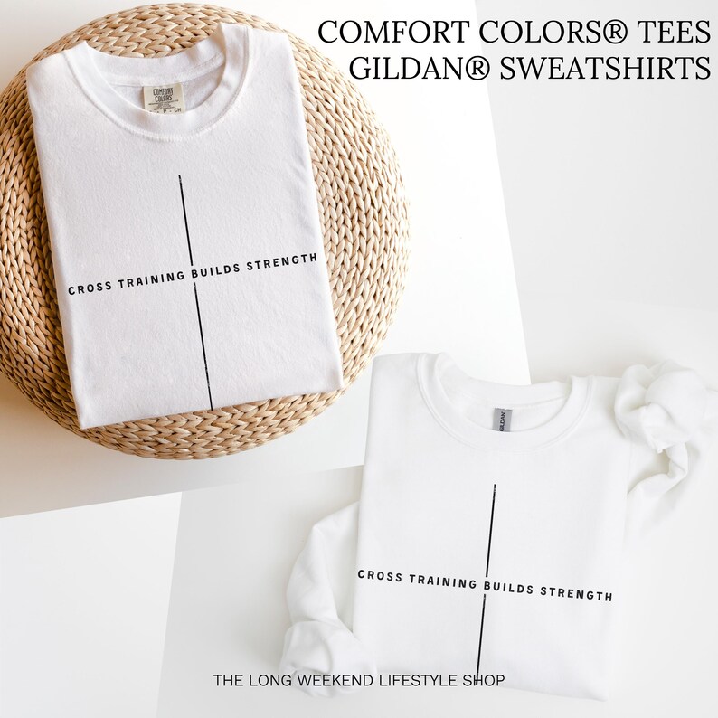 May include: Two white t-shirts and a sweatshirt are displayed. Each garment has a black vertical line and the text "CROSS TRAINING BUILDS STRENGTH." The top t-shirt is on a woven surface. The text "COMFORT COLORS TEES GILDAN SWEATSHIRTS" is at the top.
