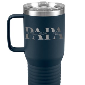 May include: A navy blue stainless steel travel mug with a black handle. The mug has a silver lid and a silver band around the bottom. The mug is engraved with the word "PAPA" and the names "Olivia", "Wilson", and "Lisa" underneath.