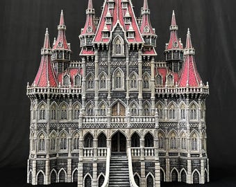 May include: A detailed model of a gothic castle with intricate stonework, red-roofed towers, and a grand entrance with a staircase. The castle is painted in shades of grey and white with accents of red.