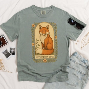 Sage green Foxtrot Delta Tango Comfort Colors T-shirt, vintage-style fox art, subtle anti-Trump activist apparel.