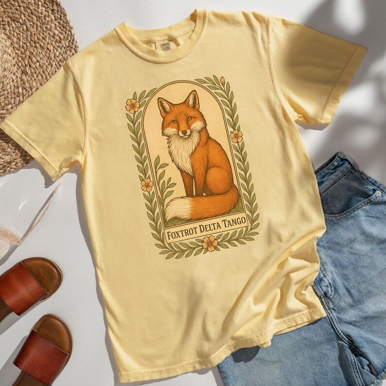 Golden yellow Foxtrot Delta Tango graphic tee, retro fox illustration, anti-MAGA Comfort Colors protest shirt.