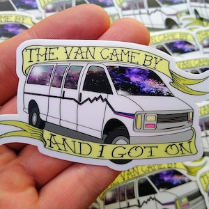 May include: A white van with a galaxy-themed design on the windshield. The van is surrounded by a yellow banner with the text "The Van Came By And I Got On".