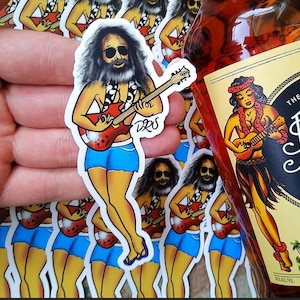 May include: A collection of stickers featuring a cartoon figure playing a guitar, wearing sunglasses, a floral necklace, and blue shorts. A bottle of Sailor Jerry Spiced Rum is also visible, with a label featuring a woman playing a ukulele.