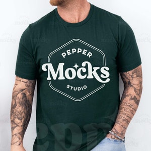 May include: A dark green t-shirt with a white logo that says "Pepper Mocks Studio" in a retro font.
