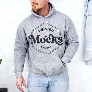 May include: A gray hooded sweatshirt with a black logo that says "Pepper Mocks Studio" in a retro font.