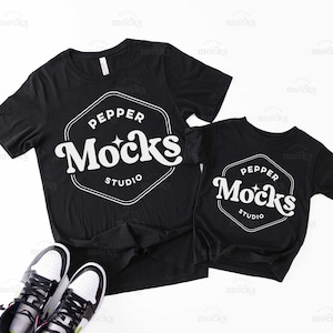May include: Two black t-shirts with a white logo that says "PEPPER Mocks STUDIO" in a retro font. The shirts are laid out on a white surface.