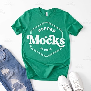 May include: A green t-shirt with a white logo that says "Pepper Mocks Studio" in a retro font.