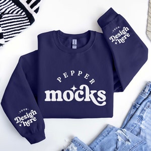 Puede incluir: Una sudadera azul marino con texto blanco que dice "Pepper Mocks" y "Your Design Here" en las mangas.