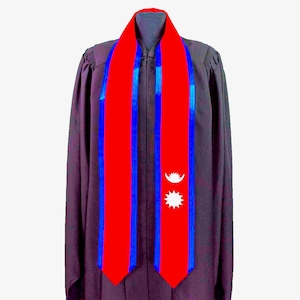 May include: A graduation stole with a red and blue design featuring the flag of Nepal. The flag has a white crescent moon and a 12-pointed white star.
