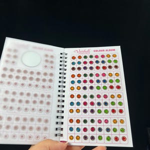 May include: A color chart for bindi stickers, featuring a variety of colors and designs. The chart is titled "Vaishali Colour Album".