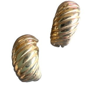 May include: A pair of gold-toned hoop earrings with a ridged design.