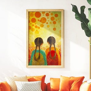 May include: A painting of two girls with long dark hair, wearing colorful dresses, standing back to back in front of a yellow and orange background with circles. The painting is framed and hanging on a wall above an orange sofa.