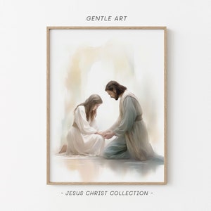 Puede incluir: Una pintura de acuarela de Jesucristo arrodillado y tendiéndole la mano a una mujer arrodillada frente a él. La pintura está en un esquema de color azul claro, blanco y beige. La pintura está enmarcada en un marco de madera claro.