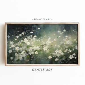 May include: A framed painting depicting a field of white flowers against a soft, green and blue background. The painting has a simple, elegant style and is ideal for adding a touch of nature to any room.