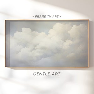 Può includere: Un dipinto incorniciato di un cielo nuvoloso in tonalità di bianco e azzurro. Il dipinto è intitolato "GENTLE ART" ed è incorniciato in una cornice sottile e dorata.