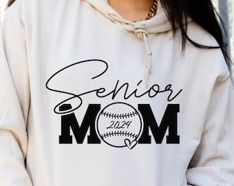 May include: A white hoodie with a black graphic that says "Senior Mom" with a baseball and the year 2024.