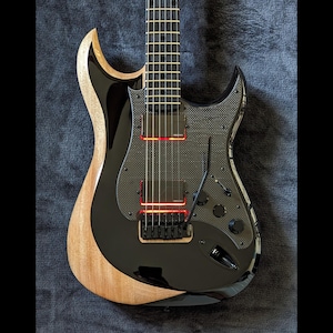 May include: A black electric guitar with a carbon fiber body and a natural wood finish on the edges. The guitar has a red LED light strip running along the body.