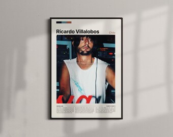 May include: Framed poster featuring Ricardo Villalobos, with the text "Ricardo Villalobos" and "Chile". The image shows a man in a white sleeveless shirt. The poster has a black frame and is displayed on a white wall.