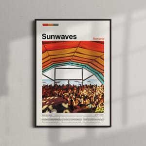 May include: A framed poster with the word "Sunwaves" in red and white, and "Romania" in red. The image depicts a crowd under a colourful tent with orange, yellow, and blue tones. The poster is in a black frame.