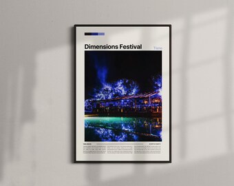 May include: A framed poster featuring the text "Dimensions Festival" above a nighttime scene with blue and teal lighting. The image shows a venue reflected in water, with a dark frame and a white border.