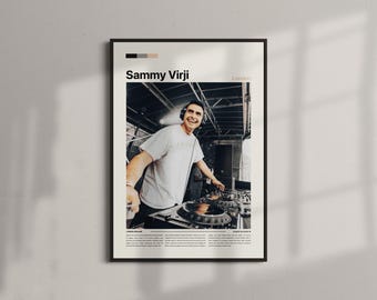 May include: Framed poster featuring a smiling man wearing headphones, operating DJ equipment. The poster has the name "Sammy Virji" and "London" printed on it. The image is in black and white with a beige border and a white wall background.