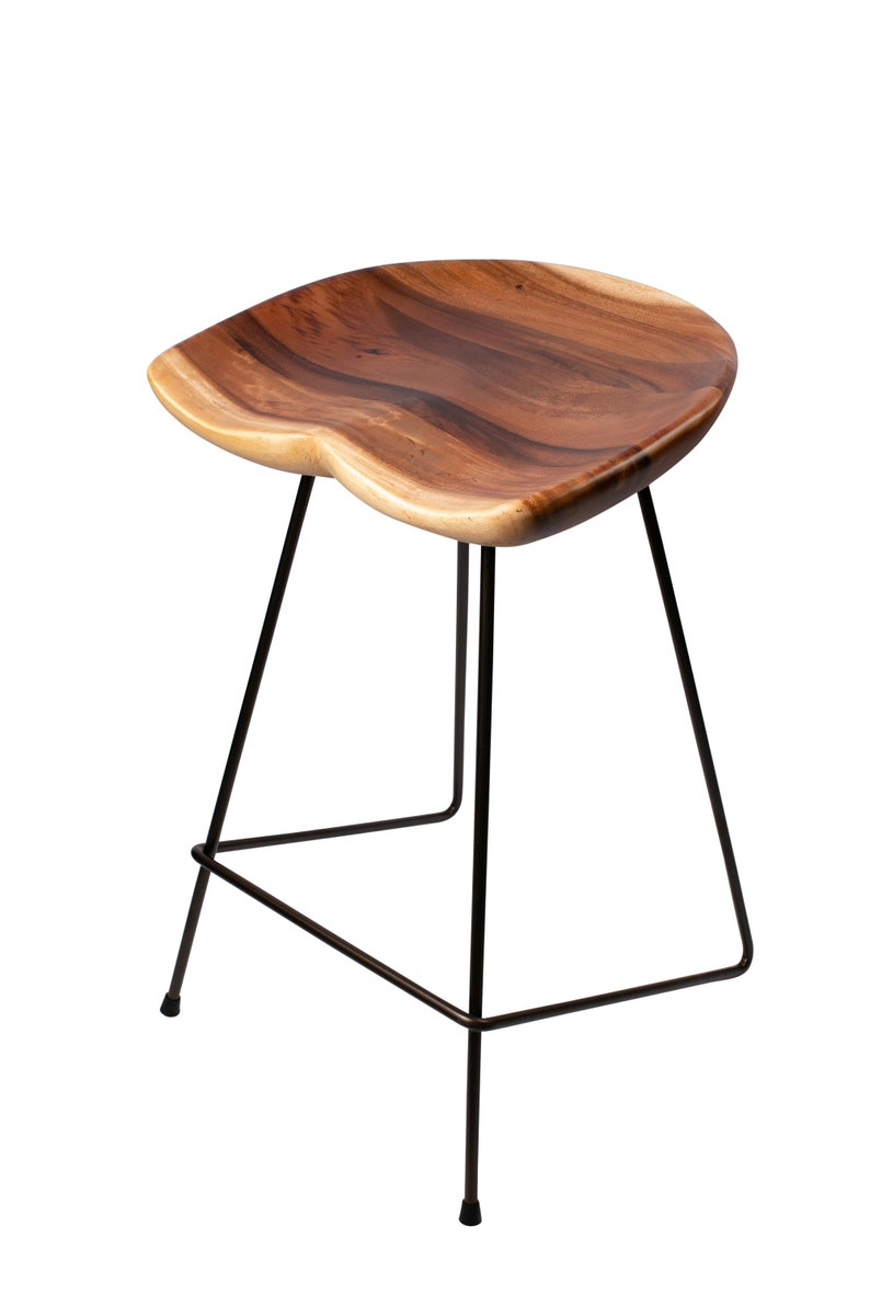 Puede incluir: Un taburete de bar de madera con un asiento contorneado y una estructura de metal negro. El asiento es de madera natural con vetas visibles. El taburete tiene un dise&ntilde;o minimalista, adecuado para cocinas o bares.