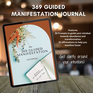 May include: A digital tablet displaying a cover for a guided manifestation journal. The cover is brown with a floral design and the text "the 369 GUIDED MANIFESTATION JOURNAL". The journal features 33 prompts and 33 affirmations to help you manifest faster.