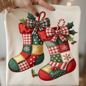 May include: A cream-colored Christmas stocking with a patchwork design. The stockings feature red, green, and gold patches, adorned with snowflakes, holly, and plaid bows. The design is festive and seasonal.