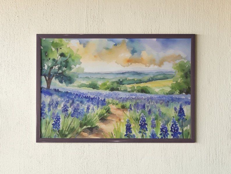 May include: Watercolour painting of a field of purple wildflowers with a path leading through the centre. The field is surrounded by rolling hills and a blue sky with white clouds.