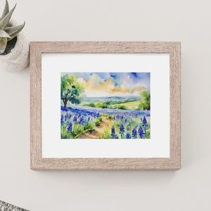May include: Watercolour painting of a field of bluebonnet flowers with a dirt path leading through the field. A lone tree stands in the distance, and the sky is a mix of blue, yellow, and white.