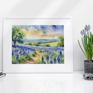 May include: Watercolour painting of a field of bluebonnet flowers with a dirt path leading through the field. A lone tree stands in the distance, and the sky is a mix of blue, yellow, and white.