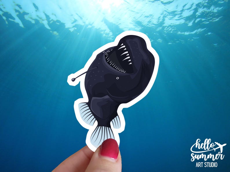 May include: A black and white sticker of a deep sea anglerfish with a large mouth and a bioluminescent lure. The sticker is on a blue background.