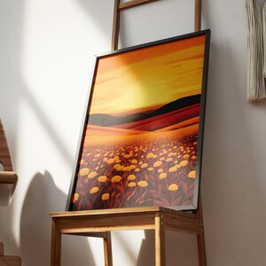 May include: A framed rectangular wall art print featuring a landscape illustration of a field of yellow flowers under a vibrant orange and yellow sunset sky, with dark rolling hills in the background and deep red tones in the foreground foliage.