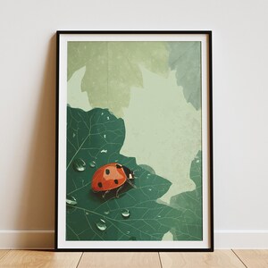 May include: Framed art print featuring a vibrant orange ladybug with black spots resting on a large green leaf. The leaf has water droplets and is set against a backdrop of other leaves in shades of green and beige.