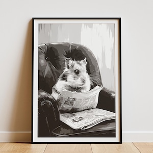 May include: Black and white framed print of a hamster sitting in a leather armchair, reading a newspaper. The artwork is a grayscale illustration with a black frame, suitable for home decor.